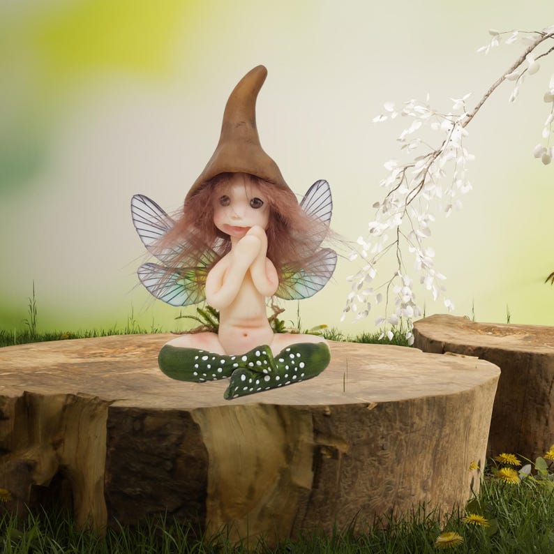 May include: A small fairy figurine with brown hair, a brown pointed hat, and green wings sits on a tree stump. The fairy is wearing a green and white polka dot dress.