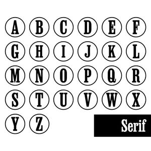 Op de afbeelding: Een verzameling van zesentwintig zwarte hoofdletters van A tot Z, elk omsloten door een dunne zwarte cirkelvormige omtrek. De letters zijn weergegeven in een vetgedrukt schreeflettertype. Het woord Serif staat in wit op een zwarte rechthoek.