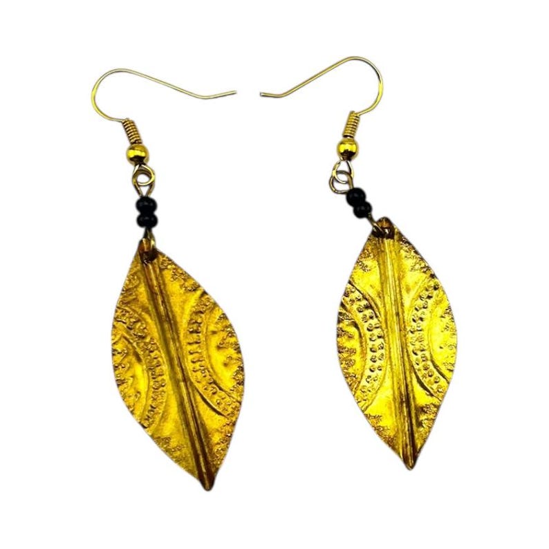May include: A pair of gold-colored leaf-shaped earrings. Each earring features a textured surface with intricate patterns and a small cluster of black beads. The earrings have gold-toned hooks.