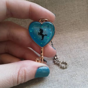 Blue sparkly heart with silhouette unicorn keychain
