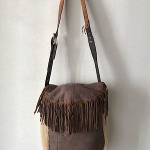 Women&#39;s Handmade  handbag made of suede and sheepskin  fur on a long handle with fringe and original details, made in the USA.