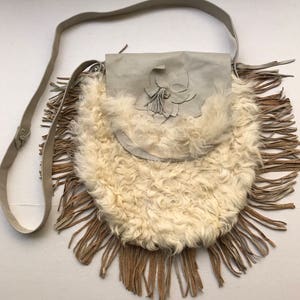 Women&#39;s white handmade handbag ;sheepskin fur bag on a long handle with fringe and original details, made in the USA.