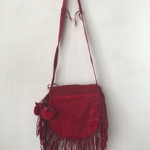 Women's handmade handbag made of leather and rubbit fur on a long handle with fringe and original details;bag cherry color;made in the USA.