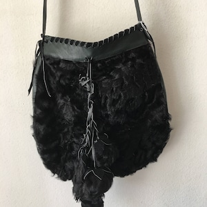 Black crossbody women&#39;s handbag, from real karakul fur, leather & suede, fluffy fur, decorated with fur bubo, new handbag, size - medium.