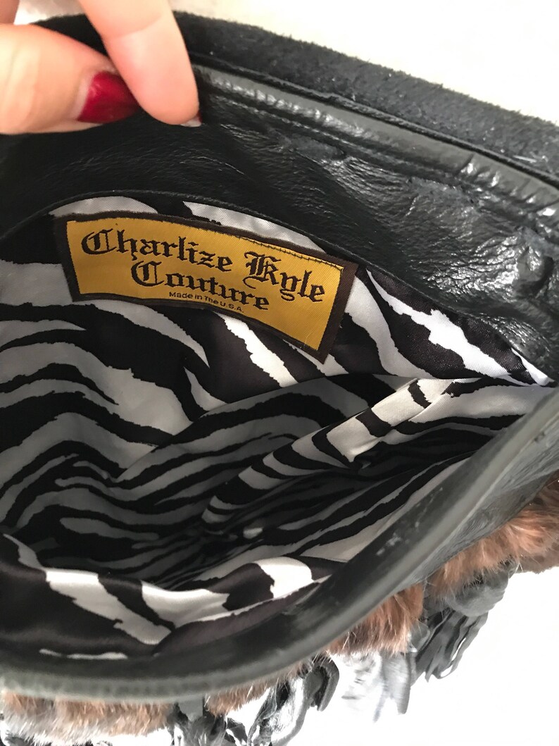 Women/'s dark brown handmade handbag made of leather and rabbit fur on a long handle with fringe and original details made in the USA.