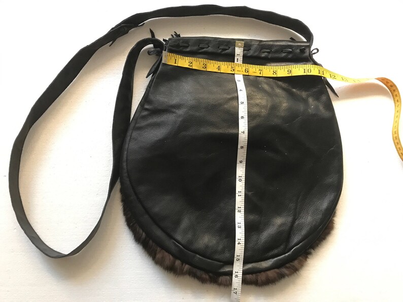 Women/'s dark brown handmade handbag made of leather and rabbit fur on a long handle with fringe and original details made in the USA.