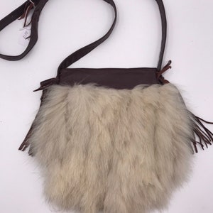 Tasche aus PolarfuchsFell Weiß Farbe und Burgunder Leder verziert mit Quasten aus Leder Größe klein made in USA.