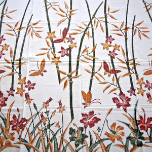 May include: White fabric with a repeating pattern of brown bamboo stalks, orange and yellow flowers, and red butterflies.