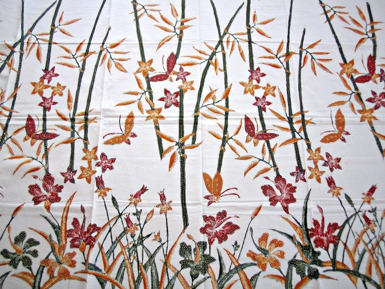 May include: White fabric with a repeating pattern of brown bamboo stalks, orange and yellow flowers, and red butterflies.