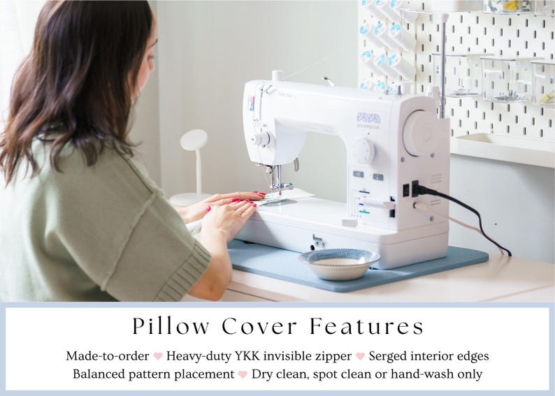 May include: A white sewing machine on a light blue mat, with a person in the background. The machine is plugged in and ready for use. A small bowl sits on the mat. The image includes the text "Pillow Cover Features".