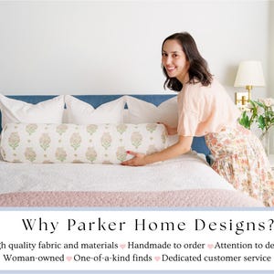 May include: A bedroom scene featuring a bed with a blue headboard, white pillows, and a patterned bolster pillow. The bolster pillow has a floral design in shades of pink and green. The text "Why Parker Home Designs?" is at the bottom.