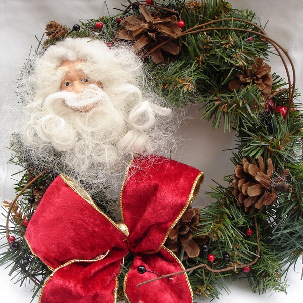 Christmas Wreath with Bisque Santa Claus Head and Pine Cones/ Wire edged Red Bow with Gold lining / Measures about10-12 inches across/ New