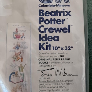May include: A white and blue packaging label for a Beatrix Potter Crewel Idea Kit featuring a 10" x 32" design of Peter Rabbit. The kit includes 100% linen fabric, 100% wool and 100% Dacron polyester Persian-type yarns, a needle, and easy-to-follow instructions. The label includes the text "The Tale of Peter Rabbit" and "Erica Wilson".