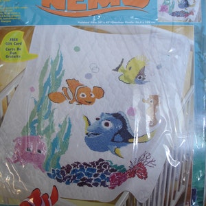 May include: A Finding Nemo stamped cross stitch kit. The design features Nemo, Dory, and other characters from the movie. The finished size is 34" x 43". Includes a free gift card.