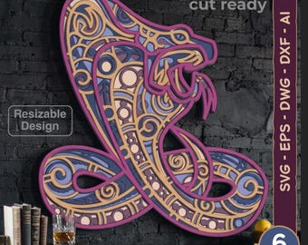 May include: A multi-layered laser cut wall art piece featuring a stylized cobra snake with intricate geometric patterns in shades of purple, blue, and cream. The design includes text labels reading laser cut ready, resizable design, and 6 layers.