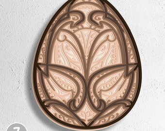 May include: A multi-layered, egg-shaped decorative design in brown and beige tones. The design incorporates detailed floral and geometric patterns. The image includes the text "7 Layers" and file type options: SVG, EPS, DWG, DXF, and AI.