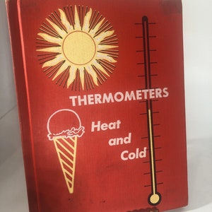 May include: A red book with the title "Thermometers: Heat and Cold" illustrated with a sun, an ice cream cone, and a thermometer.