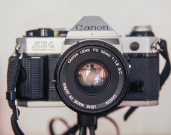 Canon AE-1 Program 35mm SLR Camera Canon fd 50mm F1.8 S.C Prime Lens. With Canon Strap, Original Canon Booklet