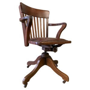 Early 20th Century Hillcrest Oak Rail Revolving Desk Chair With Polished Brown Leather Seat Finished With Brass Studs