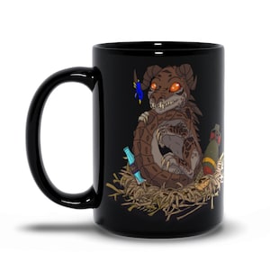 May include: Black ceramic mug with a brown and orange cartoon dragon with red eyes, sitting in a nest of twigs and holding a blue bottle. The dragon has a blue ribbon on its tail.