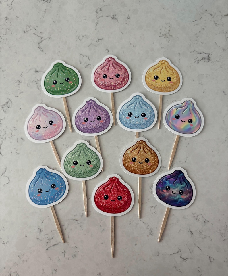 May include: A collection of twelve decorative food picks featuring cute, smiling dumpling illustrations in various colors including green, pink, yellow, purple, blue, and red. Each dumpling has a glittery finish and is attached to a wooden toothpick.
