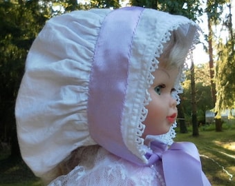 French vintage bonnet with a new violet ribbon for a collector's doll, a ceremony or historical event