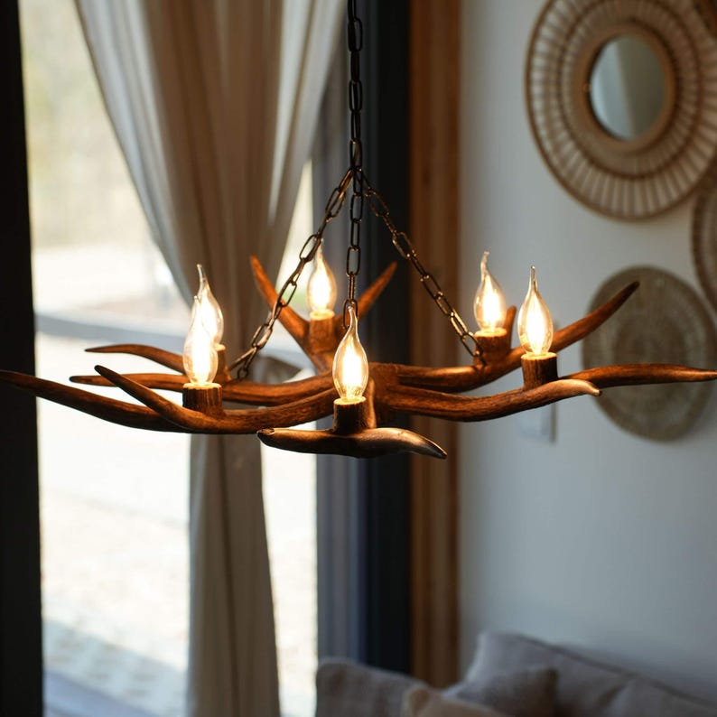 Real antler chandelier hangs in living room, over the table.