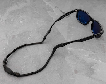 Correa fina y ajustable de cuero negro para gafas de sol. Correa para gafas de sol.