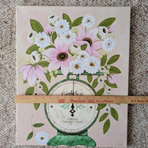 May include: A floral painting featuring a bouquet of pink and white flowers atop a vintage green scale. The scale reads "Camill Scale, CHICAGO, Capacity in pounds." The background is a soft pink.