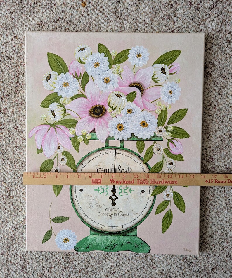 May include: A floral painting featuring a bouquet of pink and white flowers atop a vintage green scale. The scale reads "Camill Scale, CHICAGO, Capacity in pounds." The background is a soft pink.