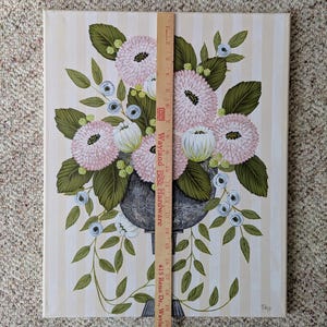May include: An original painting of a floral arrangement in a dark gray vase. The flowers are pink and white, with green leaves and blue accents. The background is a cream color with vertical stripes. The painting is approximately 23 inches tall.