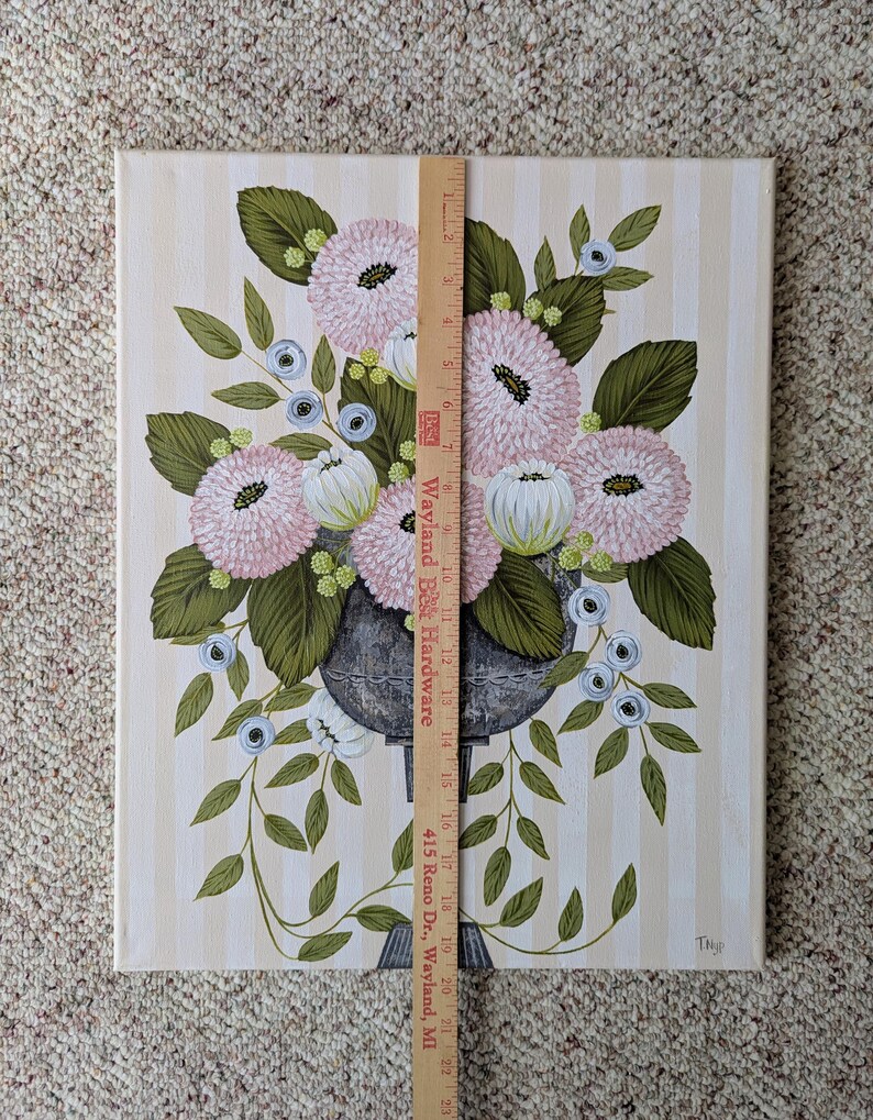 May include: An original painting of a floral arrangement in a dark gray vase. The flowers are pink and white, with green leaves and blue accents. The background is a cream color with vertical stripes. The painting is approximately 23 inches tall.