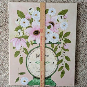 May include: A canvas painting featuring a vintage-style scale with a bouquet of pink and white flowers. The scale is green with the words "Fan Scale" and "Capacity 0 pounds". The background is a soft pink.