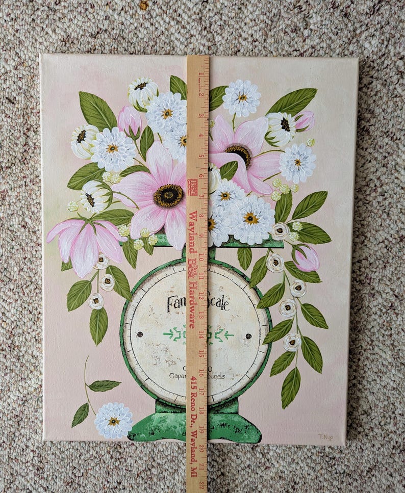 May include: A canvas painting featuring a vintage-style scale with a bouquet of pink and white flowers. The scale is green with the words "Fan Scale" and "Capacity 0 pounds". The background is a soft pink.