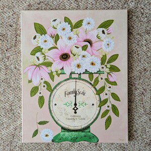 May include: A painting of a vintage green Family Scale with a bouquet of pink and white flowers. The scale face reads "Family Scale" and "Chicago Capacity in Pounds". The background is a soft pink.