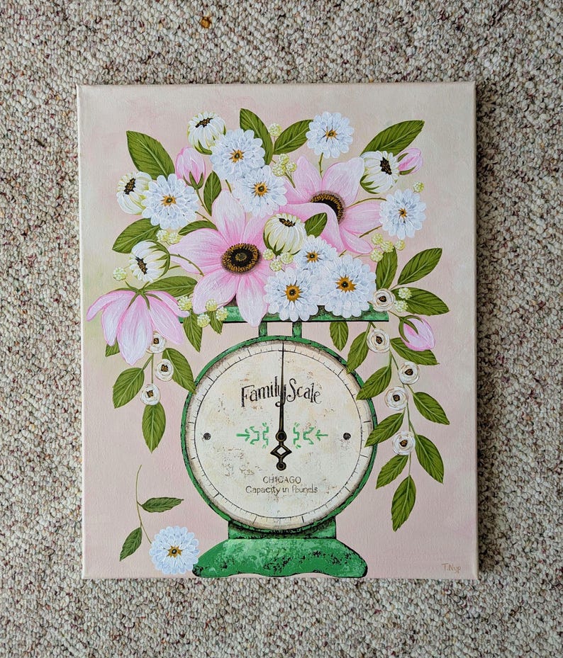 May include: A painting of a vintage green Family Scale with a bouquet of pink and white flowers. The scale face reads "Family Scale" and "Chicago Capacity in Pounds". The background is a soft pink.