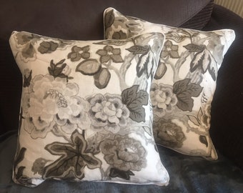 Two schumacher cushion covers in the bermuda blossom design in the snow colourway 18 inch piped/zipped.
