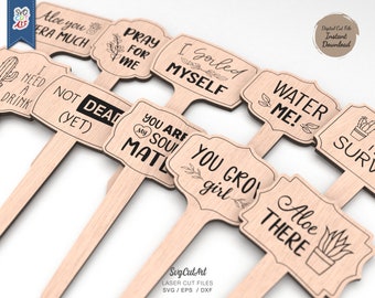 May include: Set of ten wooden garden stakes with various humorous and cute sayings. The stakes feature phrases like "Aloe You Vera Much", "Pray For Me", "I Gorled Myself", "Water Me!" and "You Grow Girl".