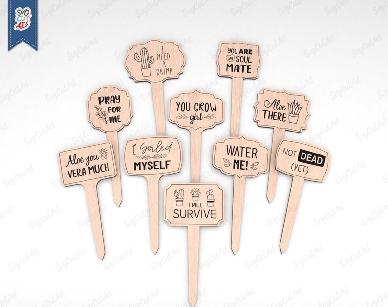 May include: Set of 11 wooden plant markers with funny and cute sayings. The markers feature a variety of designs, including a cactus, a succulent, and a heart. The sayings include "I need a drink", "You grow girl", "Aloe you vera much", "I gorled myself", "Water me!" and "Not dead (yet)".
