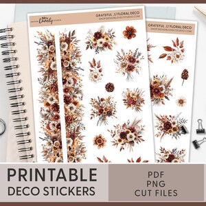 May include: Printable sticker sheet with a floral design in shades of brown, beige, and white. The sheet includes a variety of floral bouquets, borders, and individual elements. The text "GRATEFUL // FLORAL DECO" and "SHOP DESIGNLOVELYSTUDIO.COM" is printed on the sheet. The text "PRINTABLE DECO STICKERS" is printed below the sheet. The text "PDF PNG CUT FILES" is printed below the sheet.