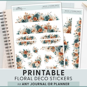 May include: Printable floral deco stickers with watercolor floral designs in teal, orange, and cream. The stickers are displayed with a spiral notebook, a pen, and a cup of coffee. Text on the stickers reads "MOOD // FLORAL DECO" and "SHOPDESIGNLOVELYSTUDIO.COM". The bottom of the image reads "PRINTABLE FLORAL DECO STICKERS FIT ANY JOURNAL OR PLANNER".