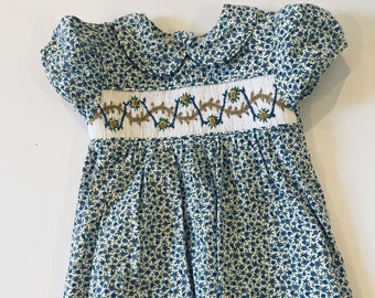 Absolutely stunning hand smocked blue floral dress! Toddler blue floral smocked at the bodice dress and with the a peter pan white collar.