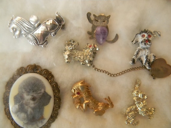 Poodle and cat brooches