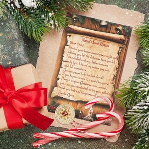 May include: A vintage-style scroll with a handwritten note from Santa Claus. The note says "Santa's Lost Button" and asks the child to help find a lost button. The scroll is surrounded by candy canes, a wrapped gift, and a snowy evergreen branch.