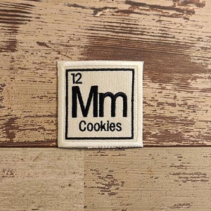 May include: A white patch with black text that reads "12 Mm Cookies" in a periodic table element style.