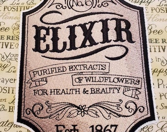 May include: A vintage-style embroidered patch with a beige background and black stitching. The patch features the word "ELIXIR" in a decorative font, along with the text "Purified Extracts of Wildflowers for Health & Beauty" and "Est. 1867".