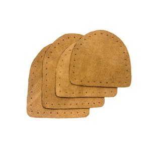 May include: Four brown leather patches with stitched edges, stacked on top of each other.