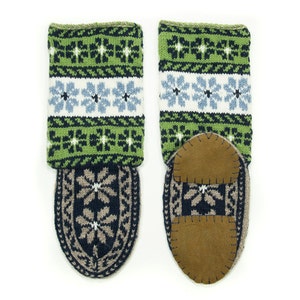 May include: A pair of green, white, and blue knitted slipper socks with brown suede soles. The socks have a snowflake pattern.