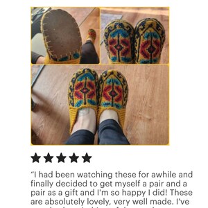 May include: A pair of yellow knitted slippers with a colorful geometric pattern. The slippers are worn and the soles are visible.