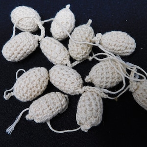 twelve acorns, creation for creation, of yarn and fabrics